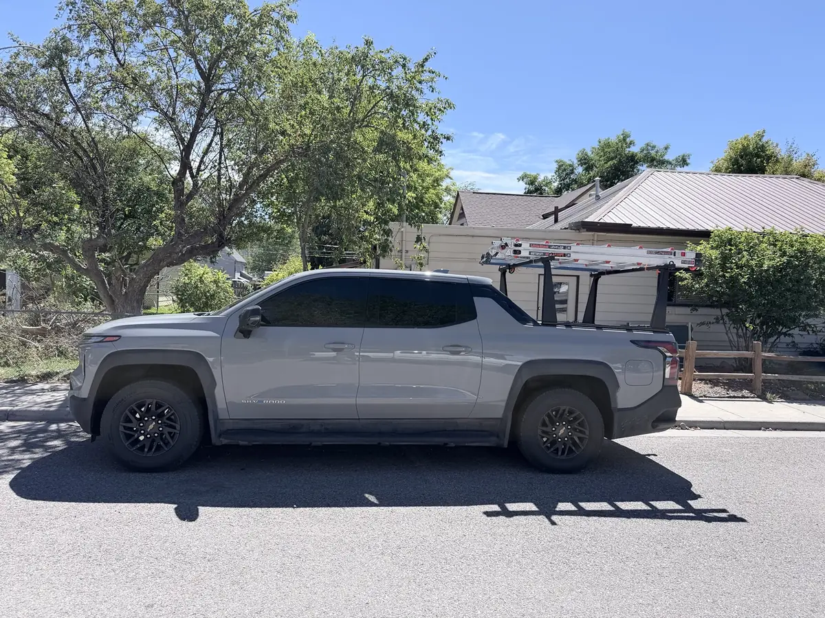 The Elite Electrical Solutions gray work truck with ladder rack, parked on a Western Colorado street.